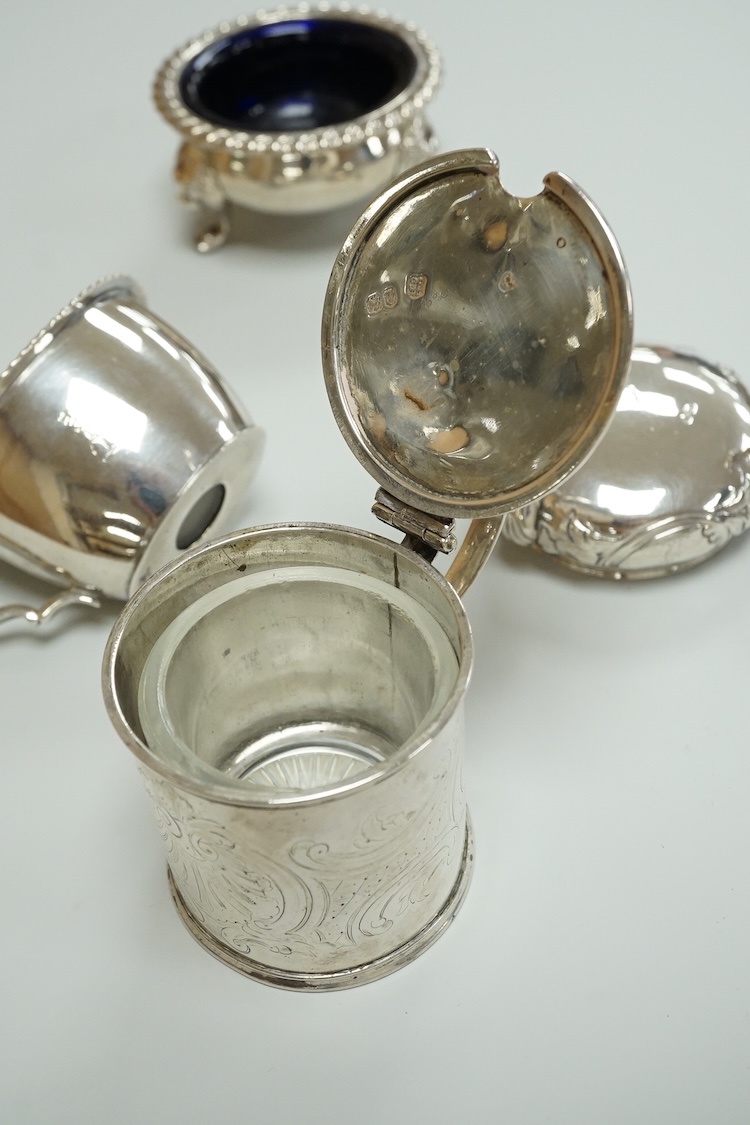 A Victorian silver drum mustard pot, a pair of later silver mustard pots and two silver salts including Victorian.